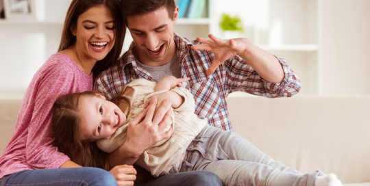 Child with parents laughing