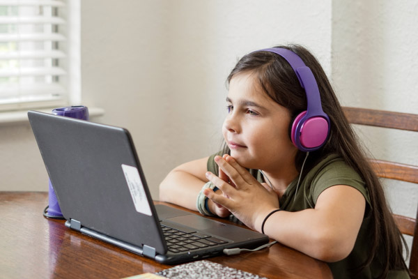 child sitting at laptop